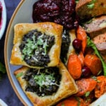 spinach puff pastry on a plate with other Thanksgiving dishes