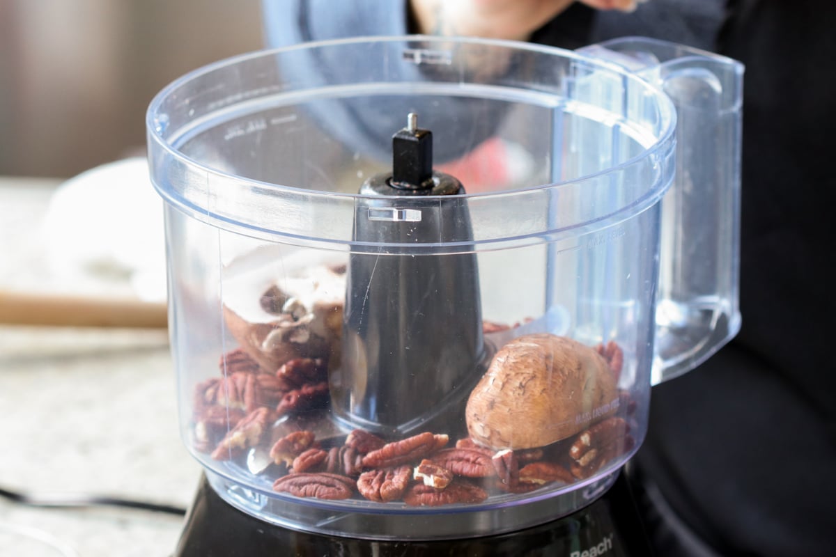 pecans, chickpeas, and mushrooms in the food processor before processing
