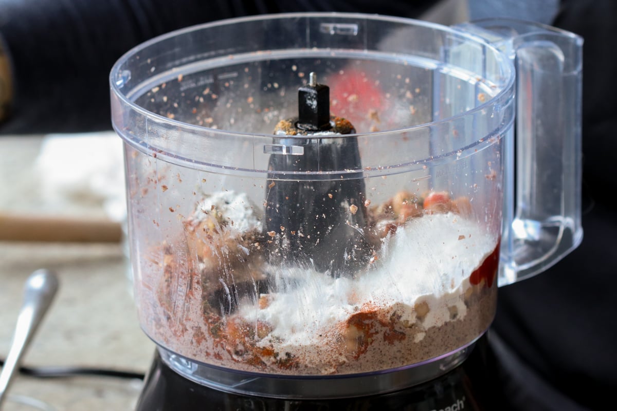 adding flour and spices to the food processor