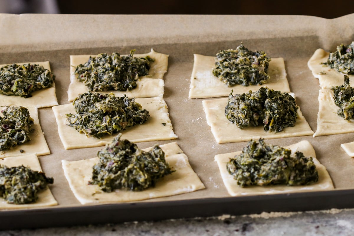 puff pastry after adding spinach mixture to the center on the baking sheet, before baking