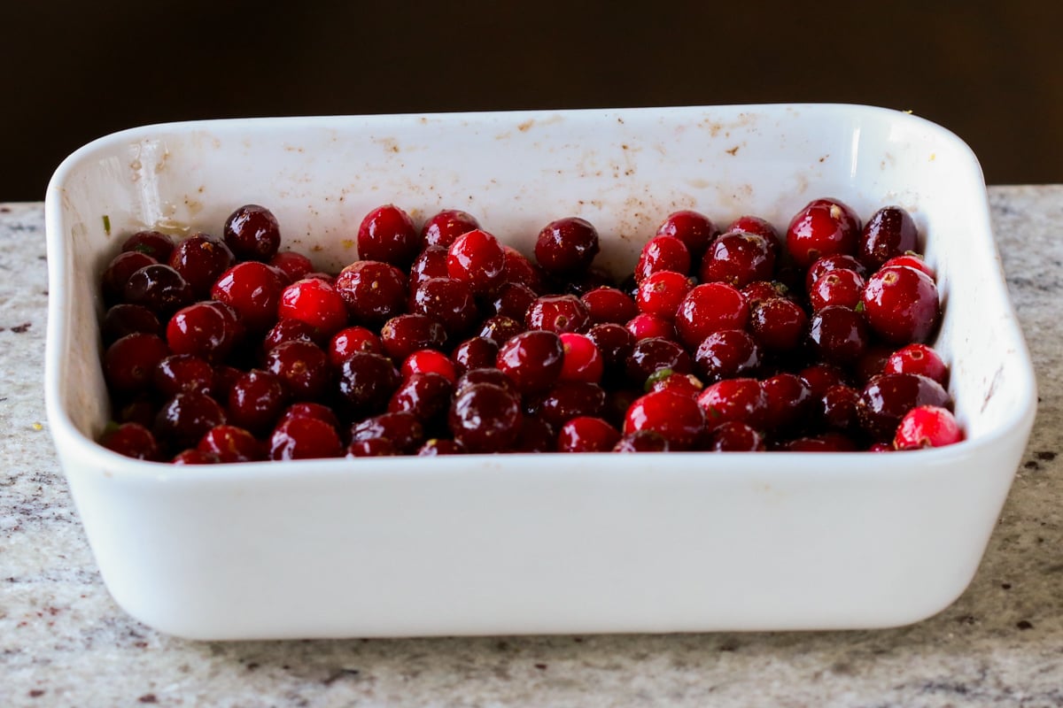 cranberries mixed with seasonings in the pan, before baking
