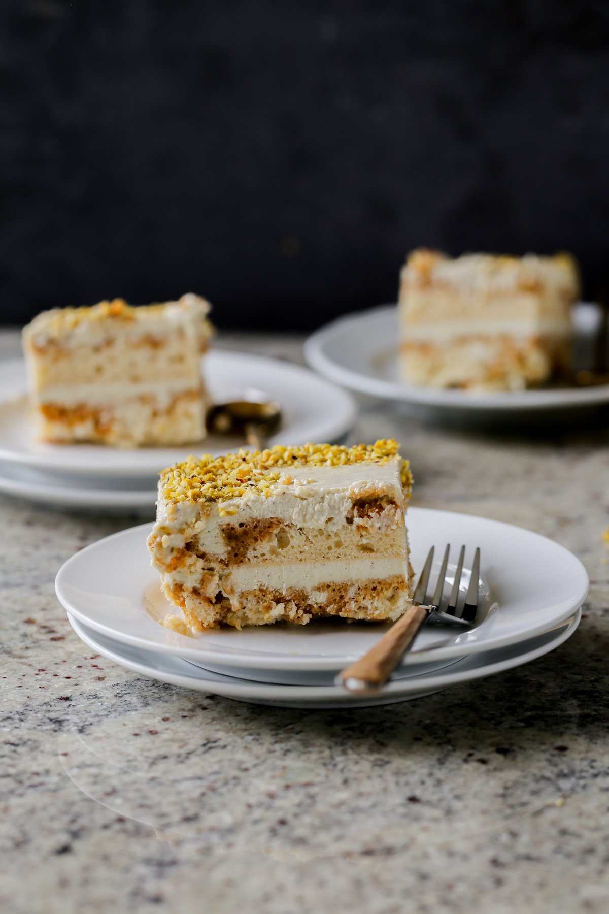 slices of kulfi tiramisu on white plates