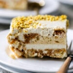 close-up of a slice of Indian tiramisu on a white plate with a fork