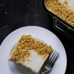 overhead photo of a slice of Indian tiramisu on a white plate with a fork
