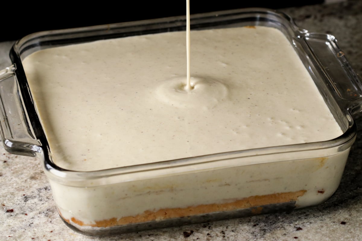 adding the second kulfi cream layer to the pan