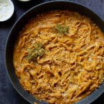 pumpkin alfredo pasta in the pan topped with the rosemary breadcrumbs