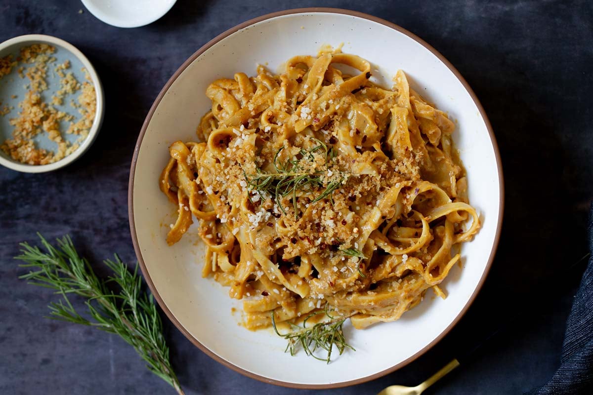 pumpkin alfredo in a bowl topped with the rosemary breadcrumbs