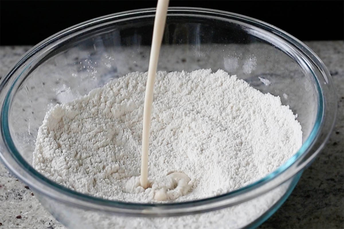 adding milk to the mixed dry ingredients