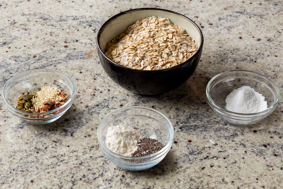 oats, flour, and spices in bowls on the kitchen counter