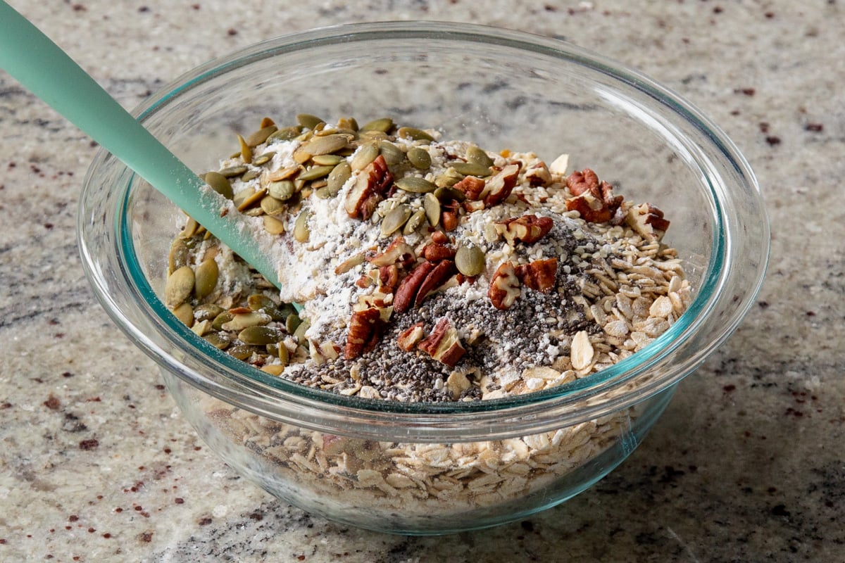 adding more nuts and seeds to the dry oats mixture