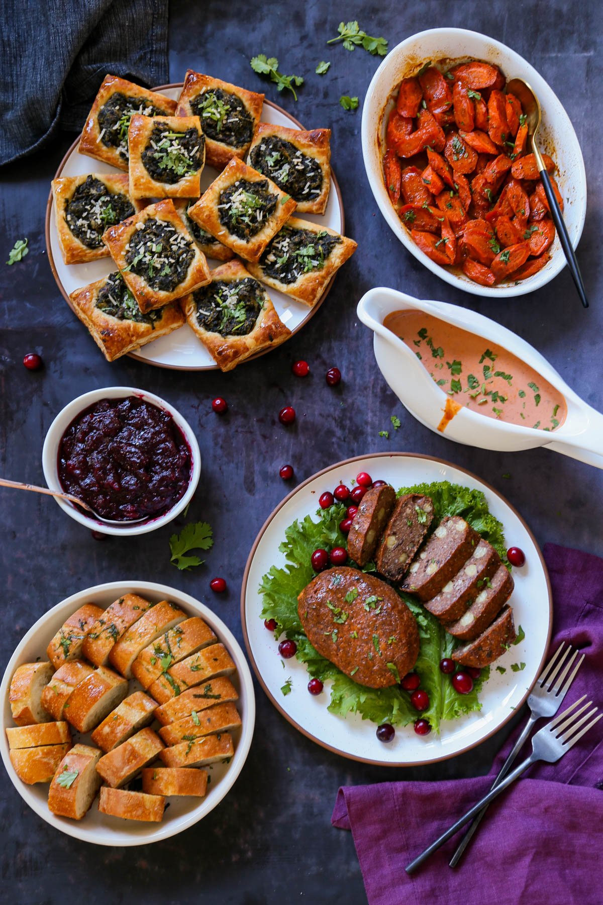 chickpea loaf with butter gravy on a plate with other Indian-style vegan Thanksgiving dishes