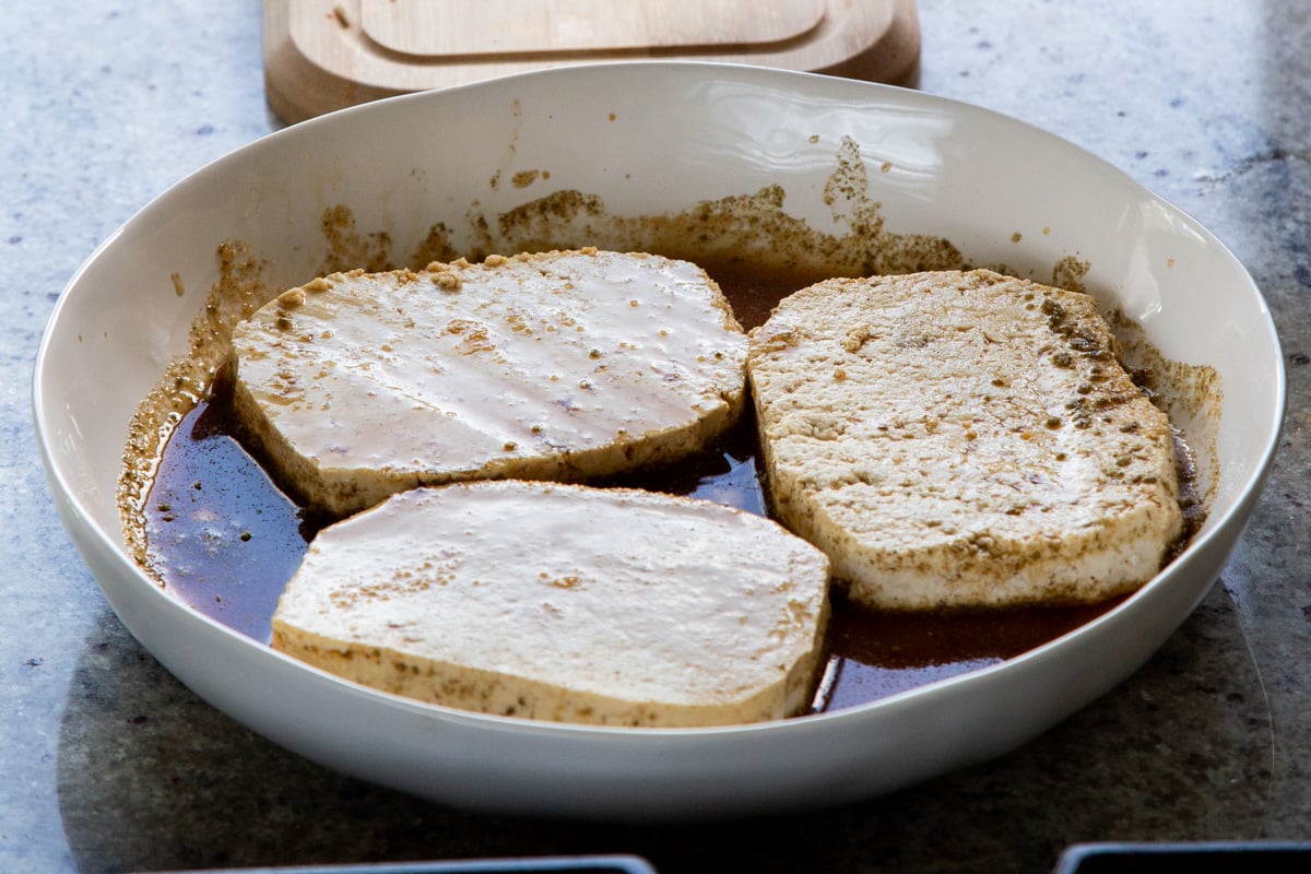 tofu cutlets in the bowl of marinade