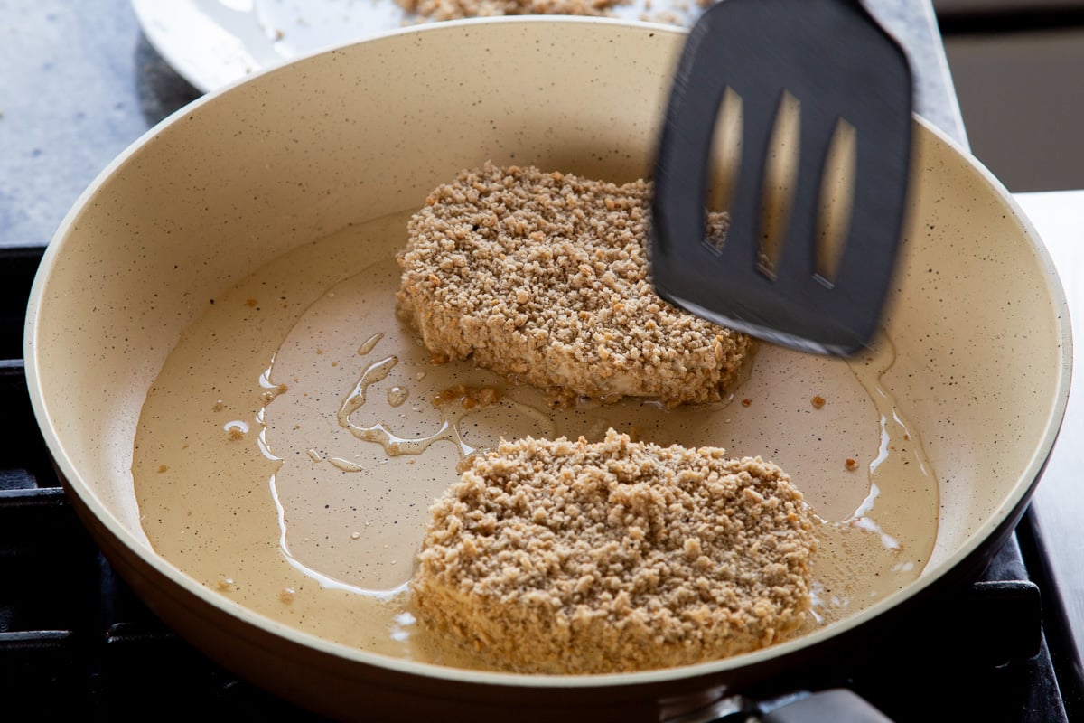 frying the tofu schnitzel in the pan