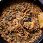 white bean stroganoff in the pan after dipping with toast
