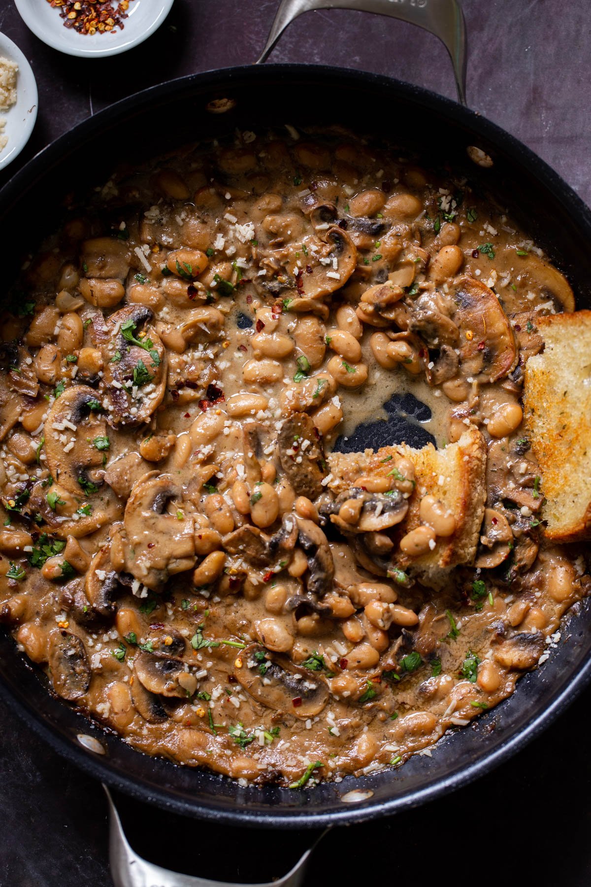 white bean stroganoff in the pan after dipping with toast