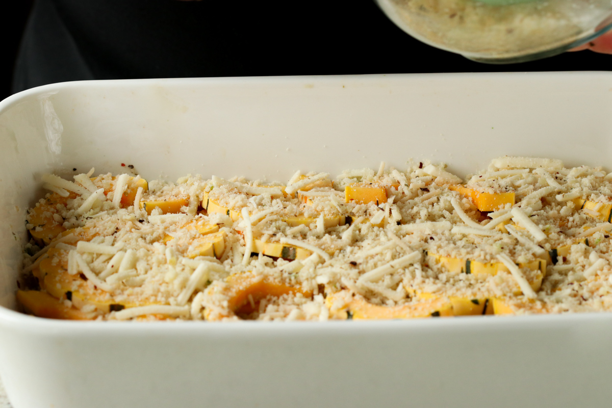 cheese-breadcrumb mixture added to the squash casserole in the pan, before baking