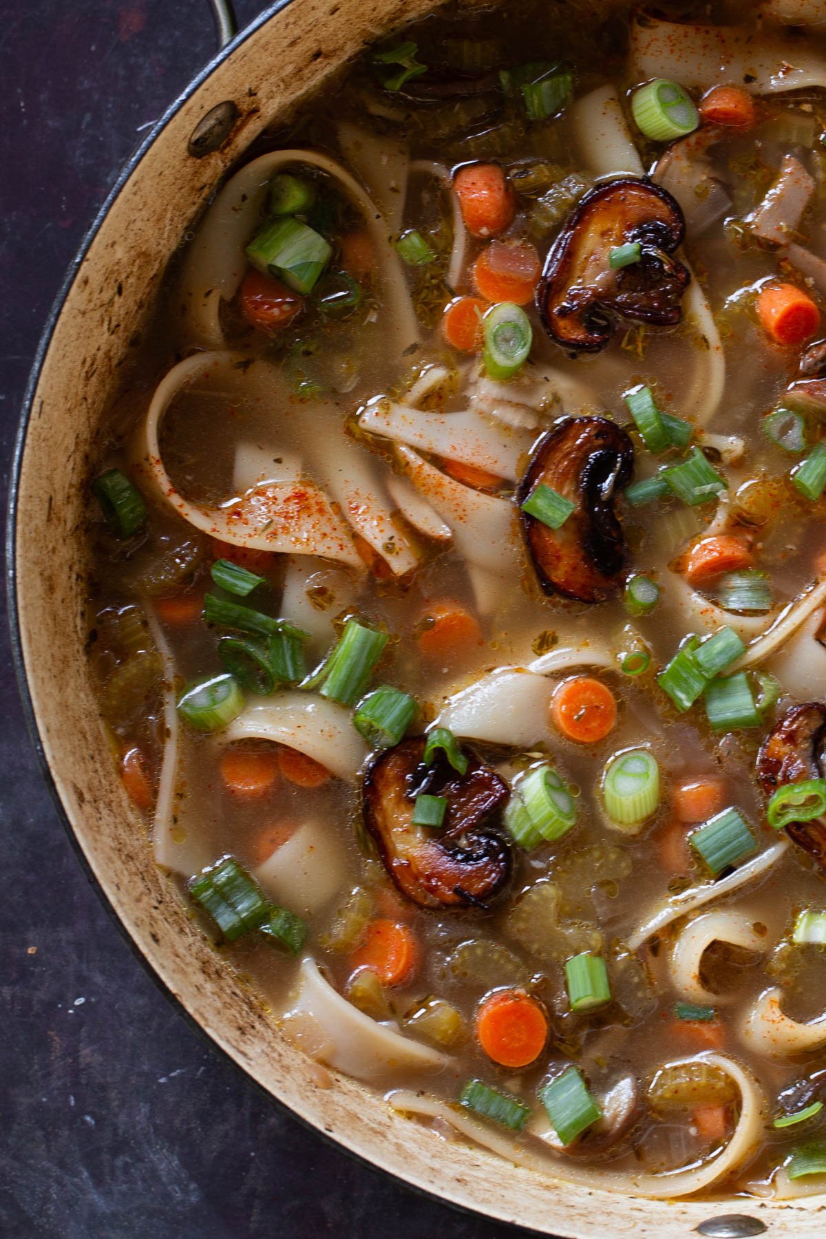 close-up of mushroom noodle soup in the pan