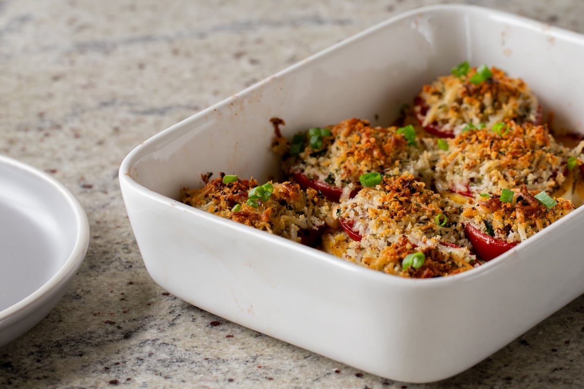 baked vegan caprese stacks in the baking dish, after baking