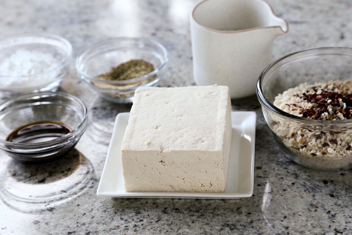 tofu, panko, and other sandwich ingredients in bowls on a kitchen counter