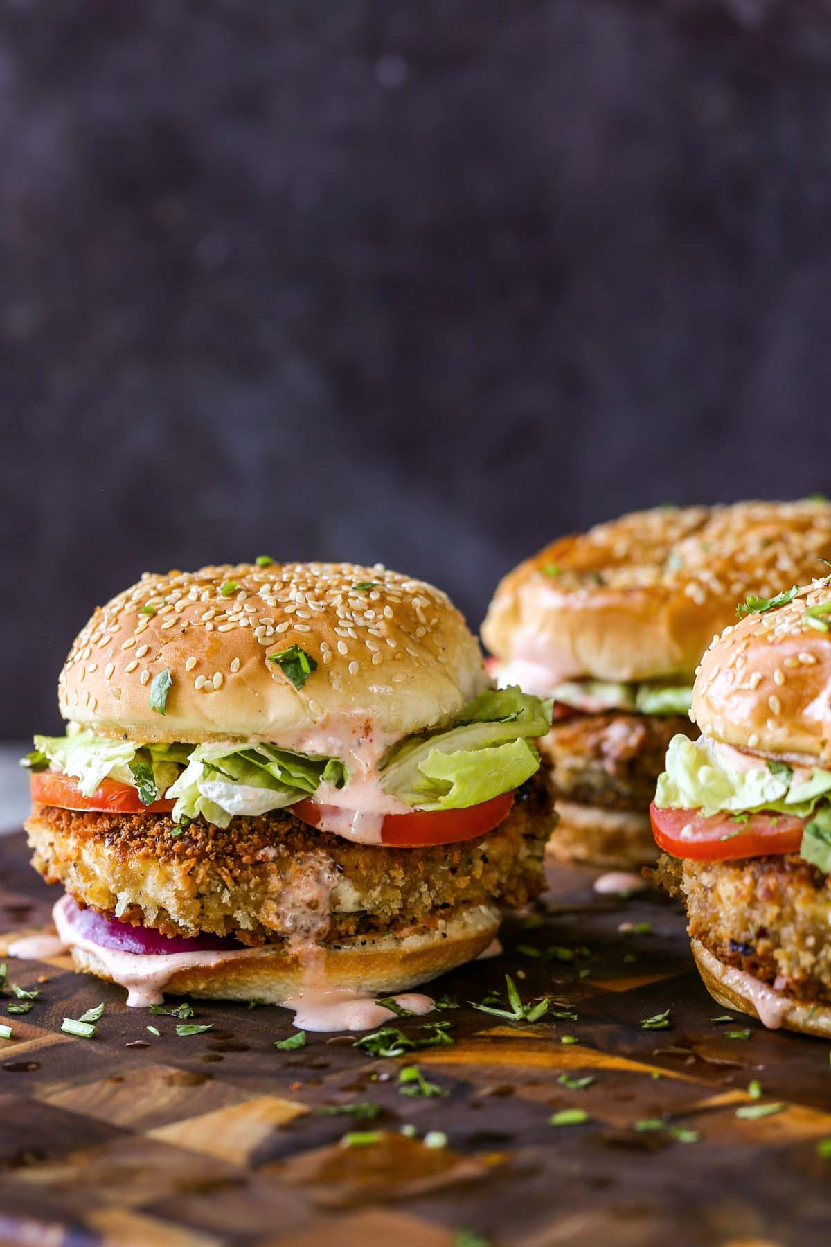 crispy vegan chicken sandwiches on a wooden cutting board