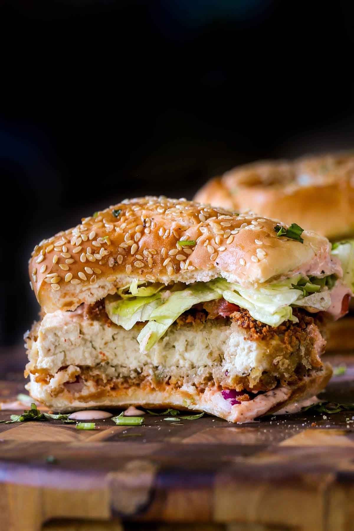 close-up of a vegan chicken sandwich with a bite taken out