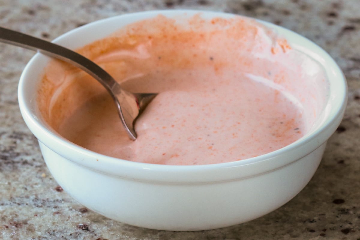 bowl of spicy mayo with a spoon in it