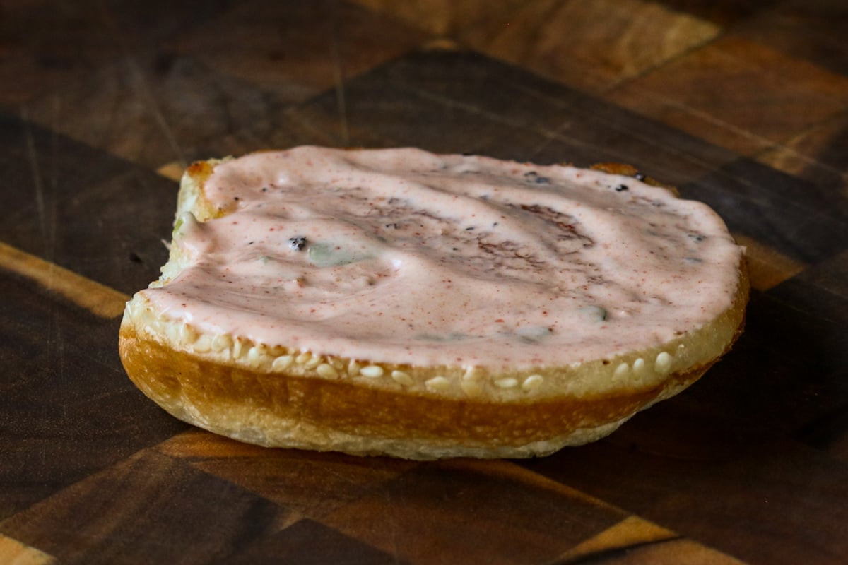 spicy mayo spread onto a toasted bun