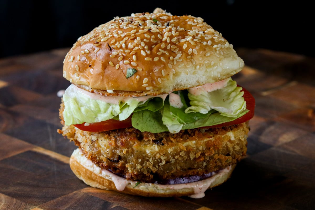 crispy vegan chicken sandwich on a wooden cutting board