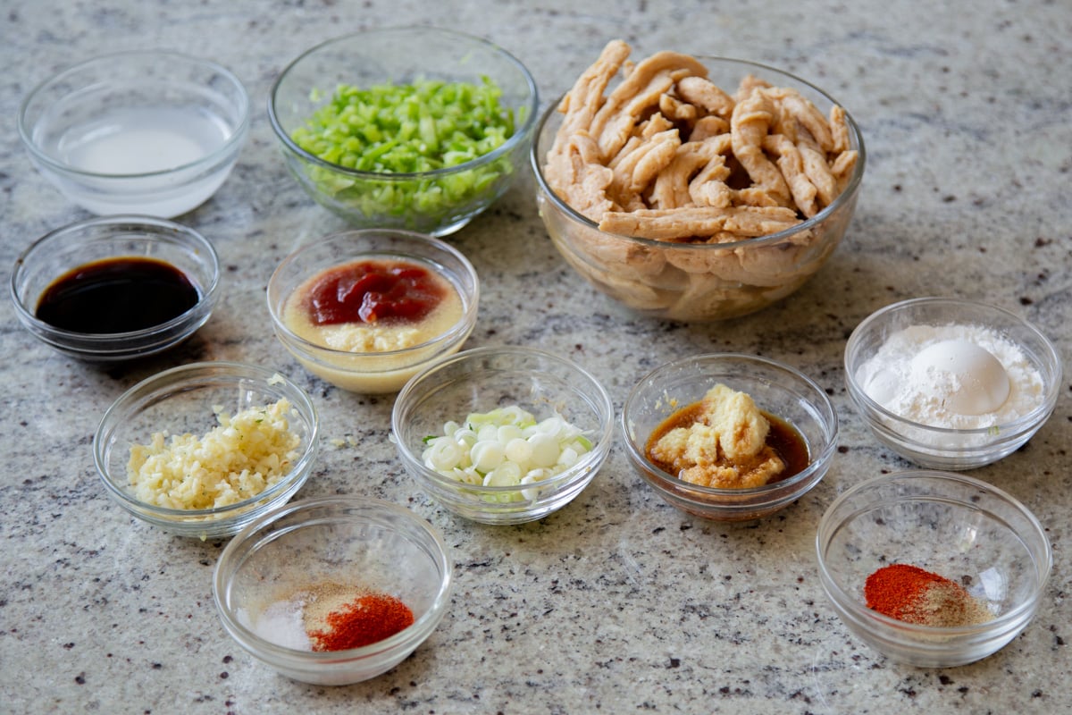 soy curls, bell pepper, and other Indo Chinese chicken ingredients in bowls on a kitchen counter