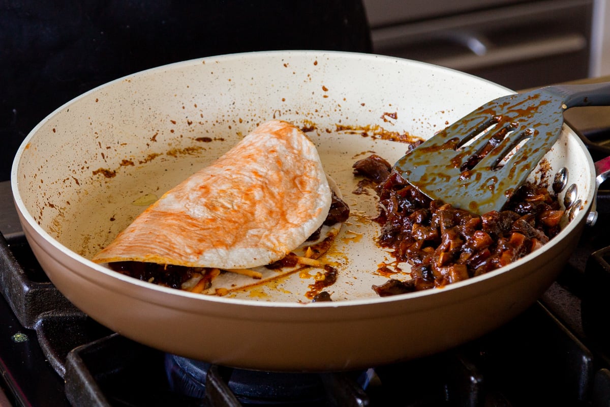 folded quesataco in the pan before flipping