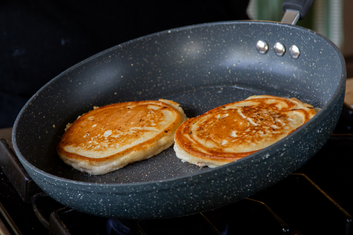 peach pancakes after flipping in the pan