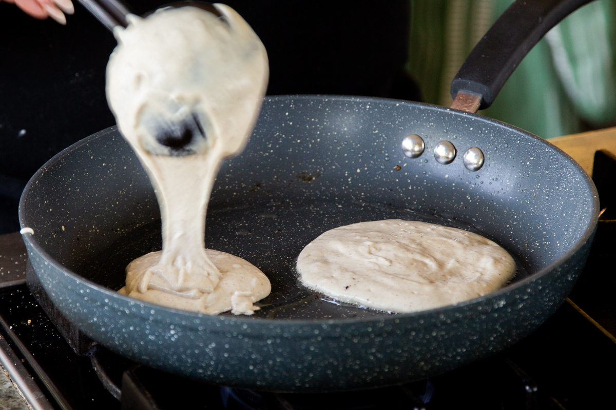spreading pancakes batter into the pan