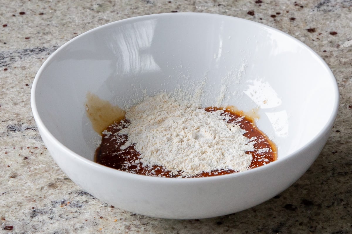 adding cornstarch to the sauces in a bowl