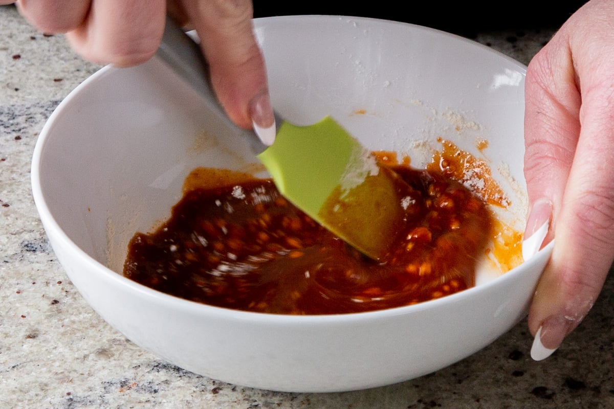 mixing the tofu marinade in a bowl