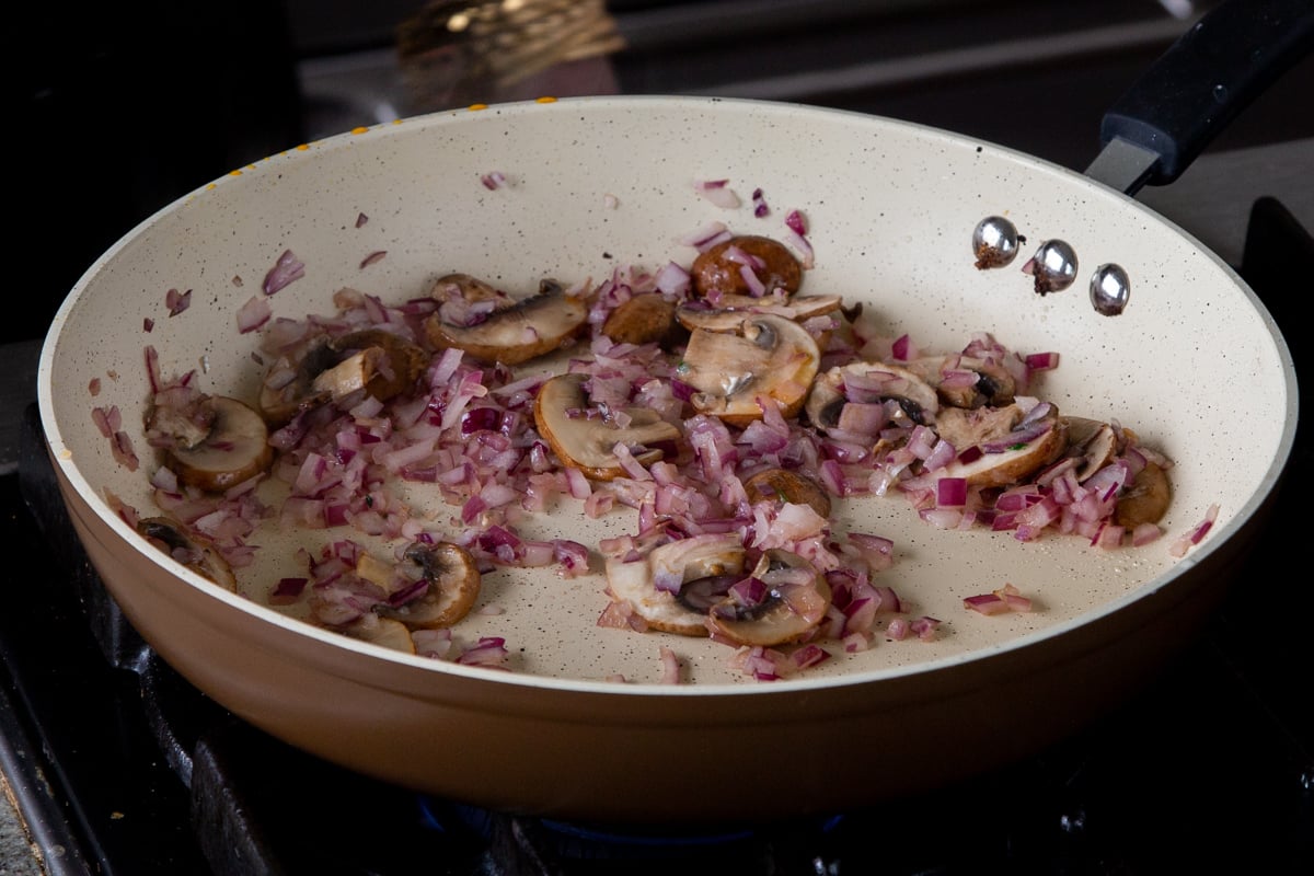onions and mushrooms in the pan after cooking