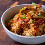 peanut gochujang rice topped with tofu and green onions in a bowl