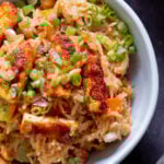 close-up of peanut gochujang rice topped with tofu and green onions in a bowl