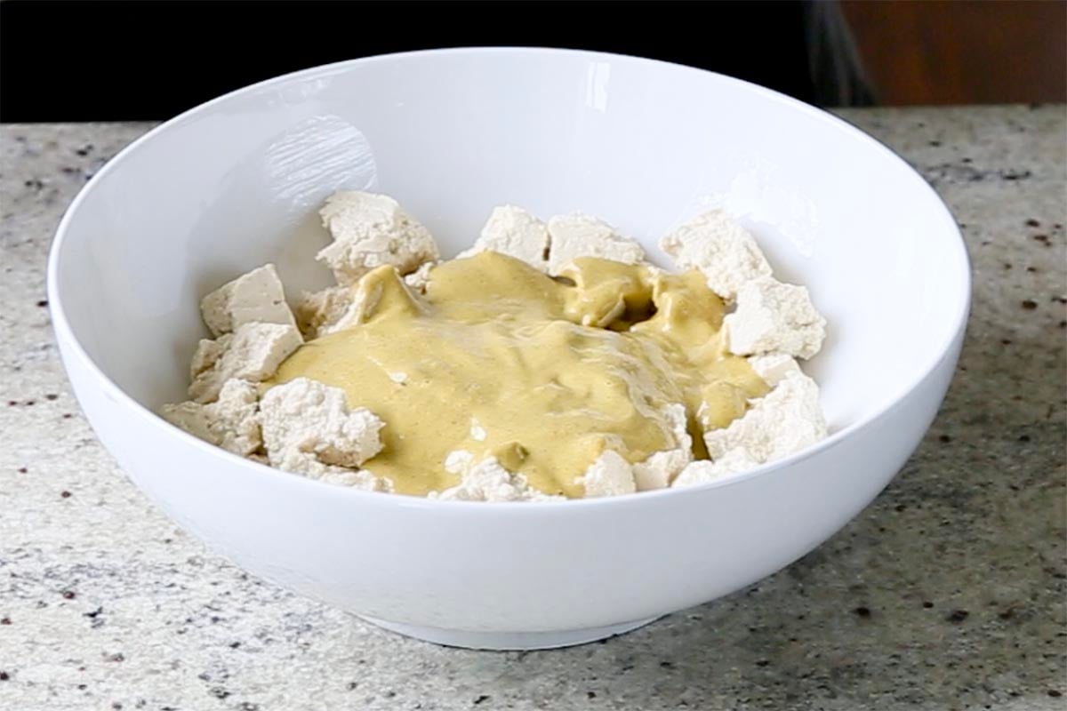 adding marinade to the tofu