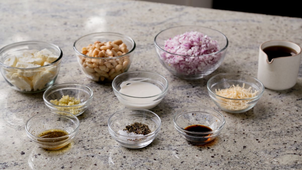 beans, cauliflower, and other ingredients in bowls on the kitchen counter