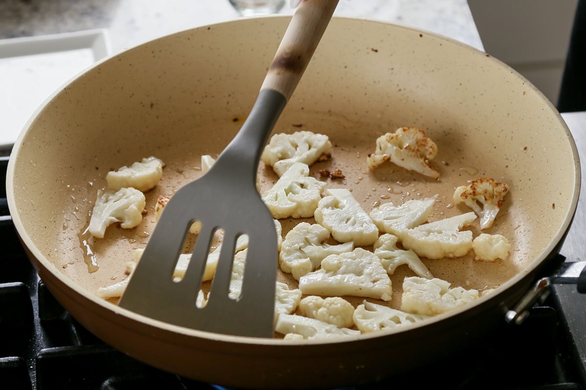 cooking the cauliflower on the skillet