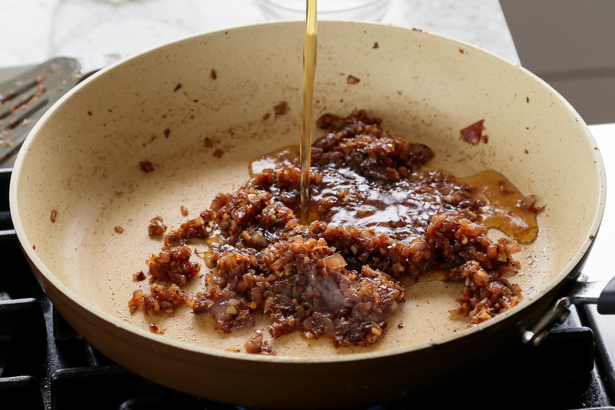 adding stock to the pan