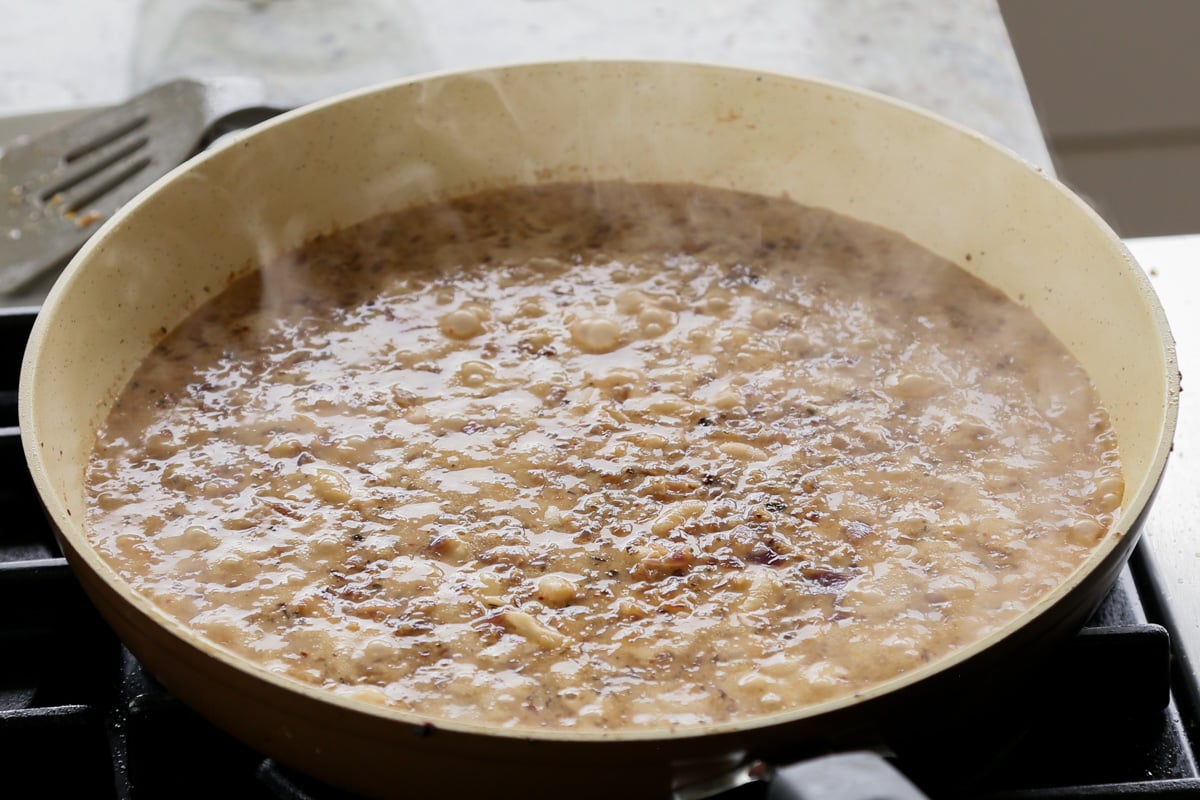 bringing the caramelized onion beans to a boil