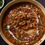 dipping sourdough into Dhaba chicken white beans