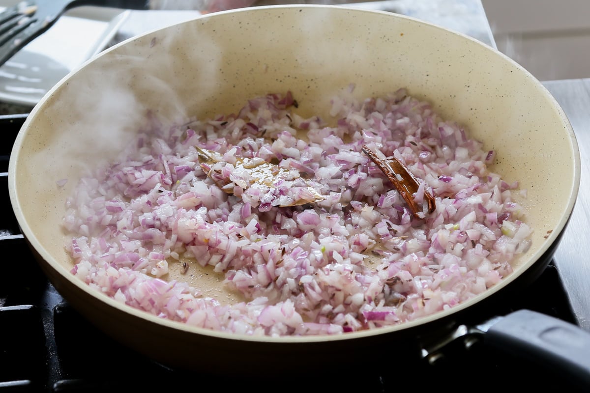 adding onions to the pan