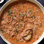 rosé sauce beans in the pan with sourdough dipped into it