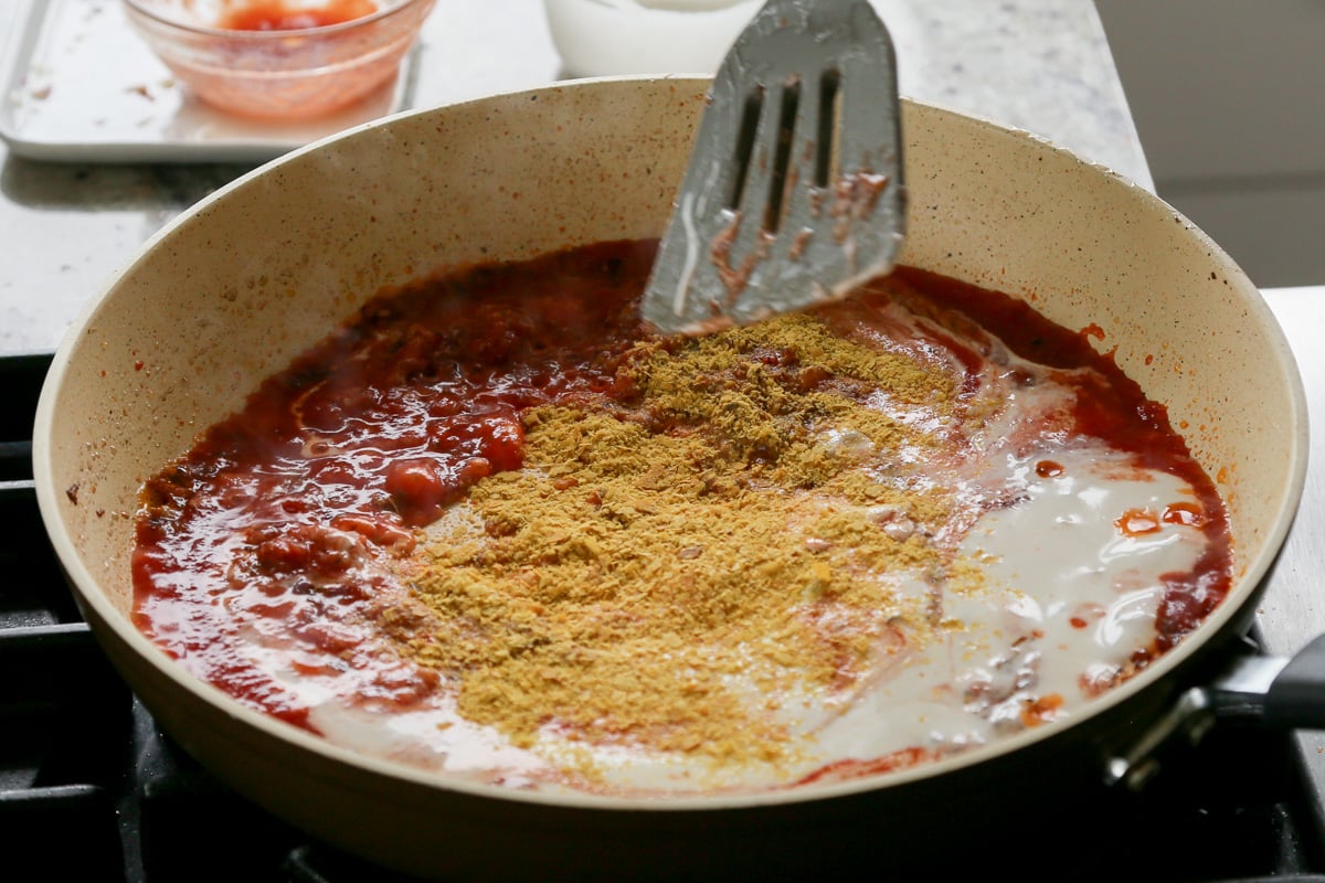 adding nutritional yeast to the pan