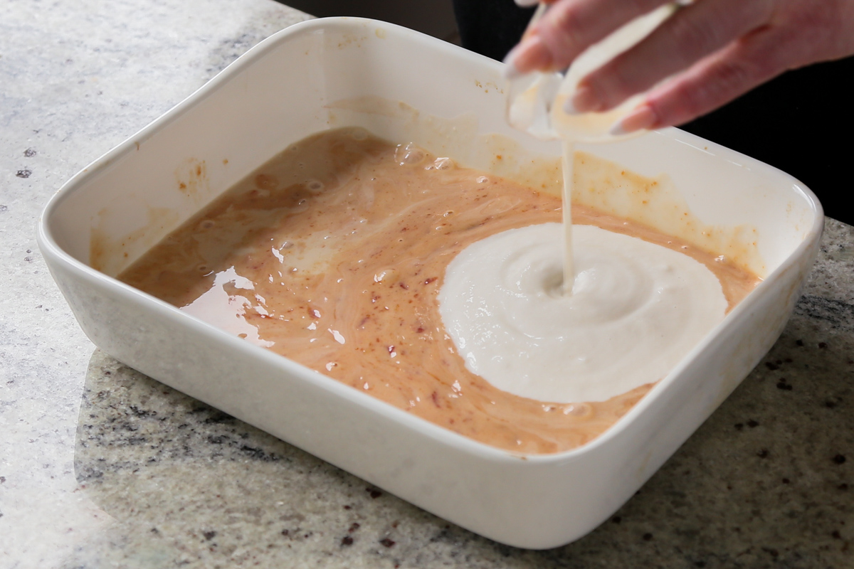 adding vegan sour cream to the sauce