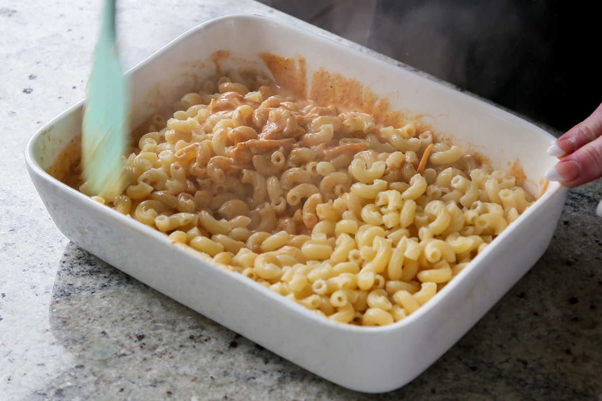 mixing the pasta into the sauce