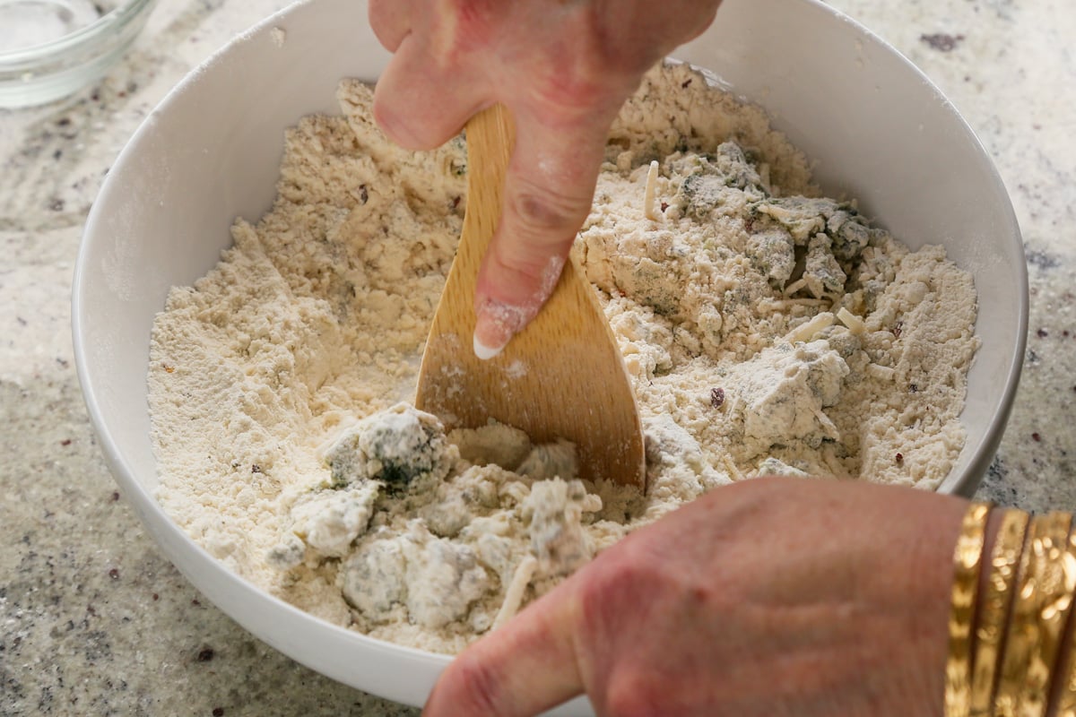 mixing the spinach and cheese into the scone dough