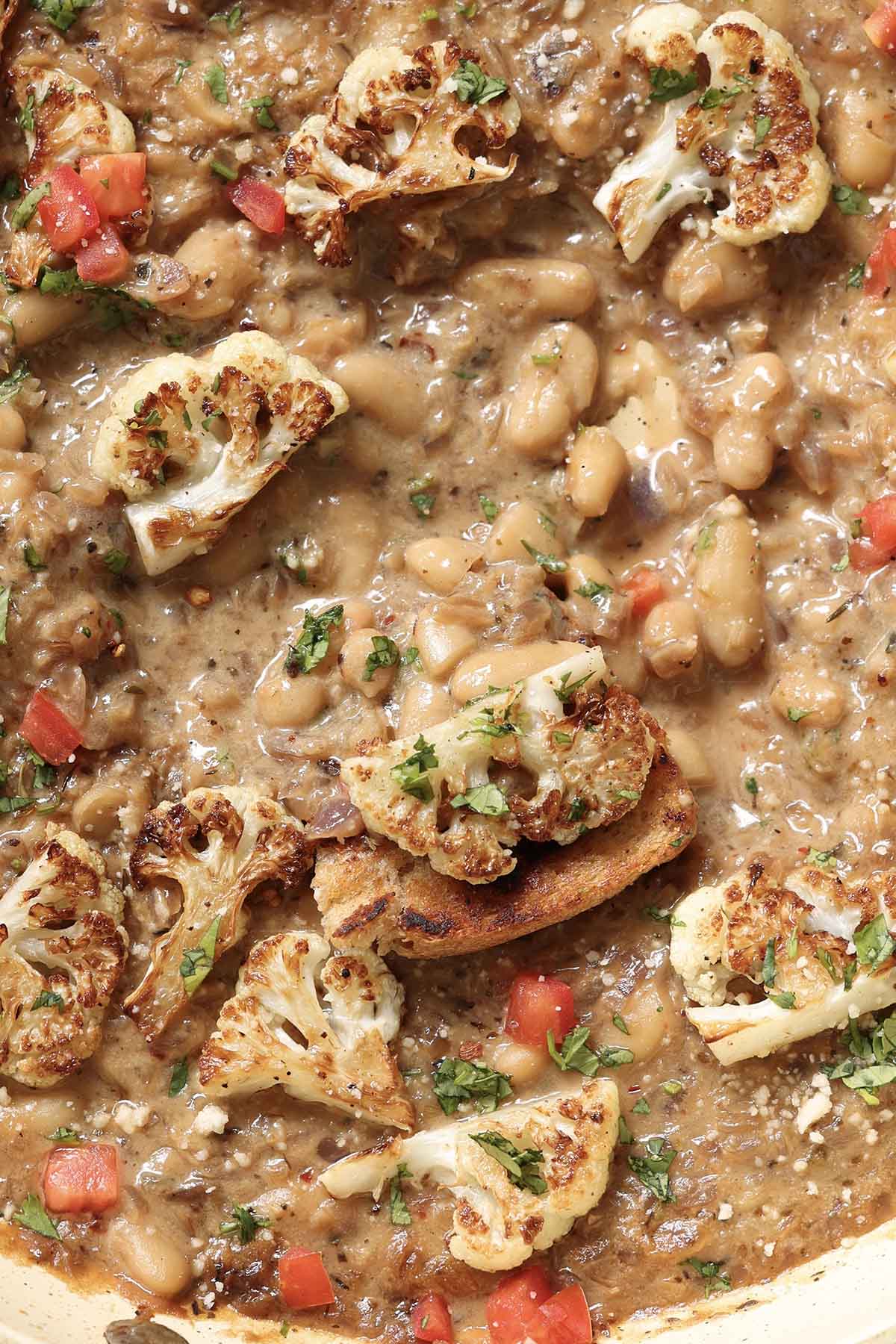 extreme close-up of caramelized onion white beans, so you can really see that amazing texture!